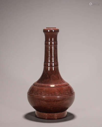 A red glazed dragon carved porcelain vase