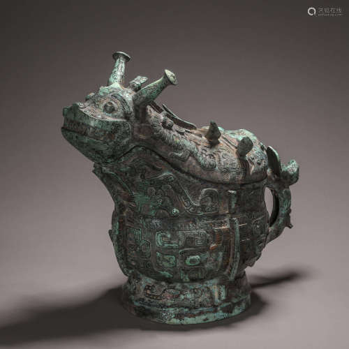 A bronze goat head pot