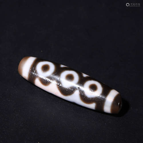 A Tibetan five-eyed cinnabar dzi bead