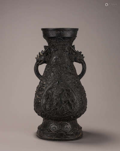 A figure carved copper vase