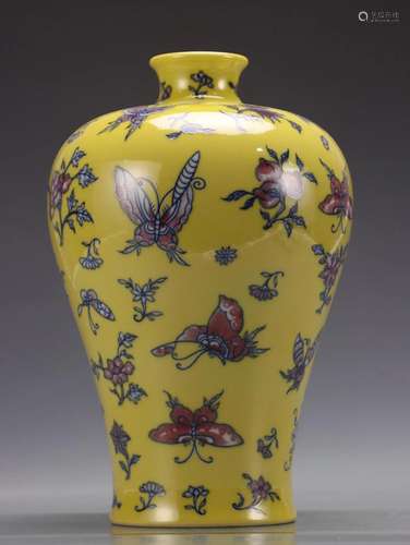 A Yellow Glazed Vase With Butterfly Pattern