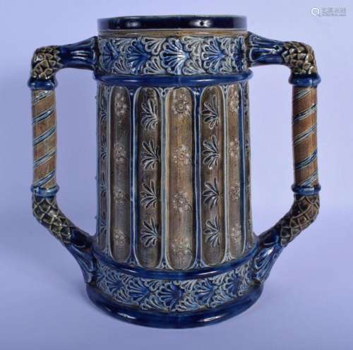 AN ARTS AND CRAFTS TWIN HANDLED STONEWARE CUP decorated with...