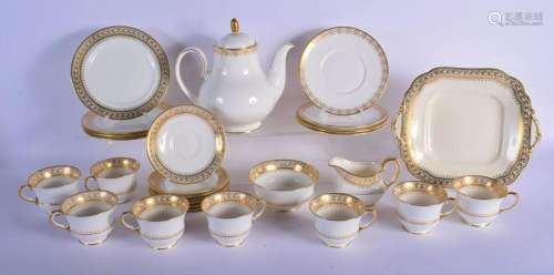 AYNSLEY TEA SERVICE FOR EIGHT, DELICATELY DECORATED IN GOLD....