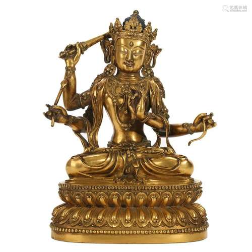 A GILT-BRONZE FIGURE OF FOUR-ARMED BUDDHA