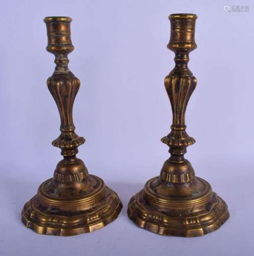 A PAIR OF 19TH CENTURY EUROPEAN BRONZE CANDLESTICKS with a s...