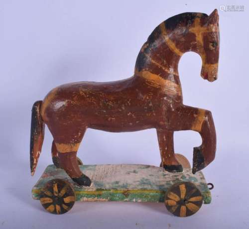 A VINTAGE FOLK ART PAINTED PULL ALONG HORSE. 18 cm x 21 cm.