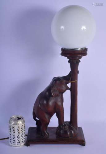 AN EARLY 20TH CENTURY INDIAN CARVED HARDWOOD ELEPHANT LAMP w...