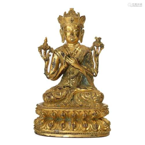 A GILT-BRONZE FIGURE OF SEATED LAMA