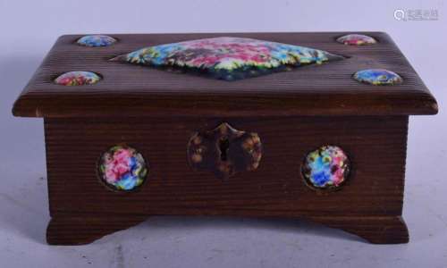 AN ART DECO CARVED WOOD AND ENAMELLED CASKET painted with fl...