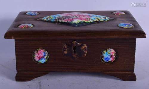 AN ART DECO CARVED WOOD AND ENAMELLED CASKET painted with fl...