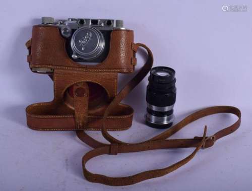 A LEATHER CASED LEICA CAMERA together with a lens. (2)