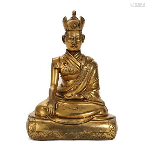 A GILT-BRONZE FIGURE OF A SEATED LAMA