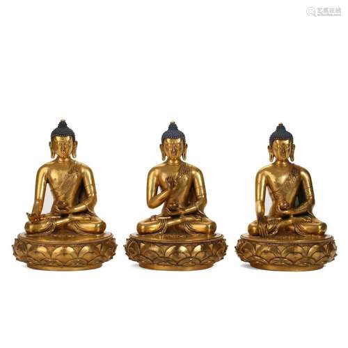 THREE GILT-BRONZE SEATED BUDDHA FIGURES