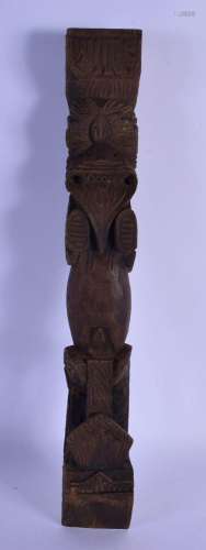 AN UNUSUAL TRIBAL CARVED WOOD POST FINIAL formed as a scowli...