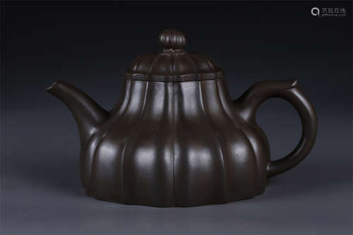 A Petal Shaped Purple Clay Teapot.