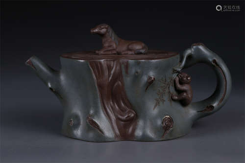 A Stump Shaped Purple Clay Teapot.