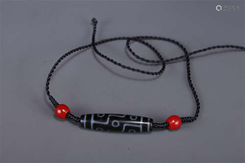 A Necklace of Nine-Eye Dzi Bead.