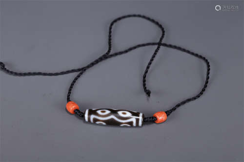 A Necklace of Seven-Eye Dzi Bead.