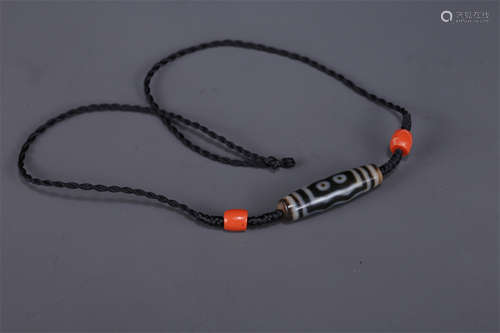 A Necklace of Five-Eye Dzi Bead.