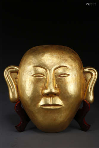 A Gilt Copper Facial Mask.