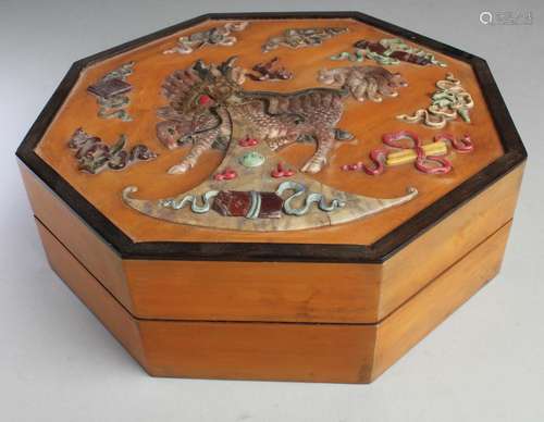 AN OCTAGONAL-SHAPED WOODEN BOX