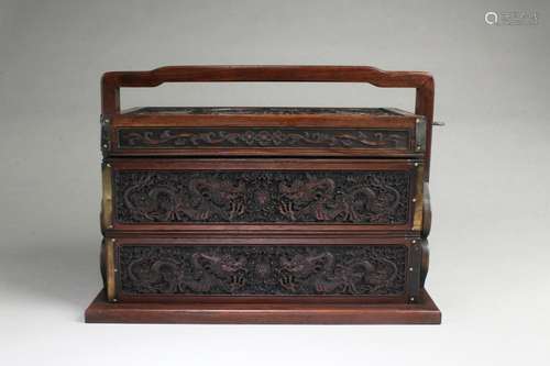 A CARVED WOODEN MULTI-TIER CONTAINER