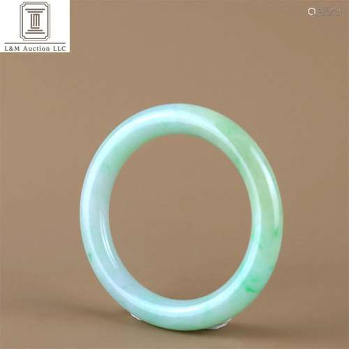 A Chinese Carved Jadeite Bracelet