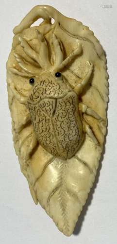 A Japanese Carved Bone Netsuke, depicting A Beetle on a Leaf