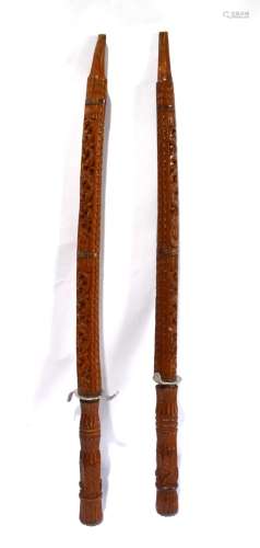 A Two of Indonesian Carved Timber Sheathed Swords