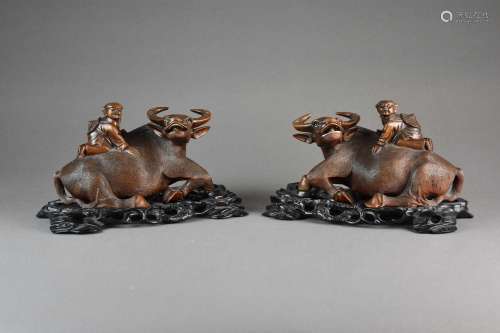 A pair of Chinese carved root wood figures of boys on buffal...