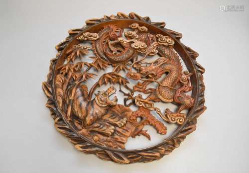 A South East Asian carved sandalwood roundel