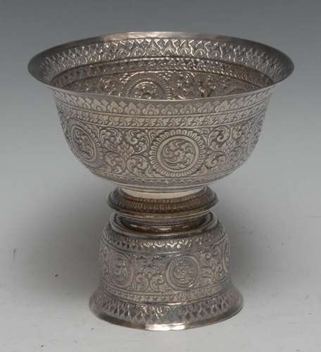 A Tibetan silver butter lamp bowl, profusely chased with man...