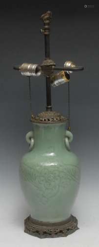 A Chinese celadon baluster vase, incised with flowers and le...