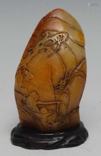 A Chinese butterscotch carving, 8cm long, hardwood stand