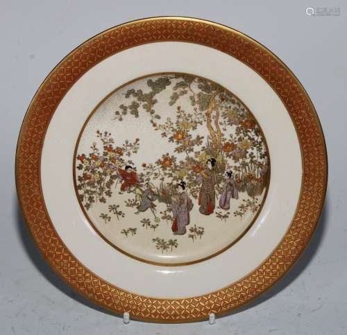A Japanese Satsuma plate, painted with geishas and boys with...