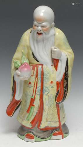 A large Chinese porcelain figure, of Shou Lao, he stands, ho...