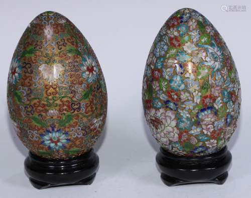 A pair of Chinese gilt metal and raised cloisonne eggs, each...
