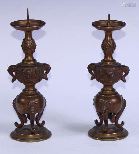 A pair of Japanese gilt bronze pricket candlesticks, cast wi...
