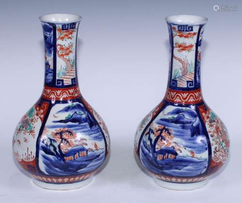 A pair of Japanese Imari ovoid bottle vases, painted with al...