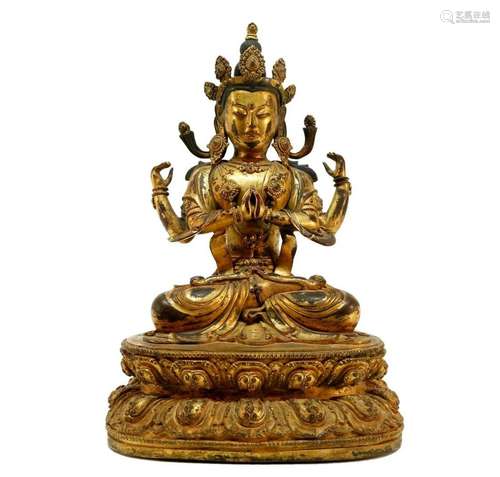 A gilt bronze Four armed Guanyin statue