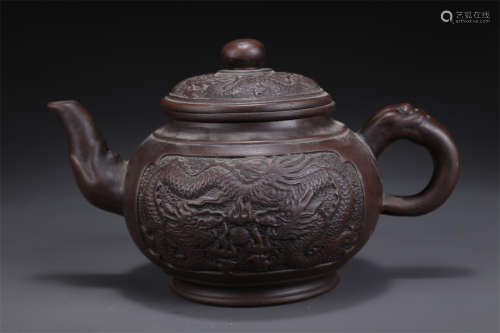 A Purple Clay Teapot with Dragon Design.