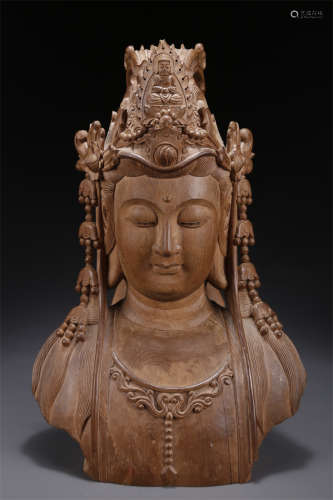 An Ormosia Fir Avalokitesvara Statue.