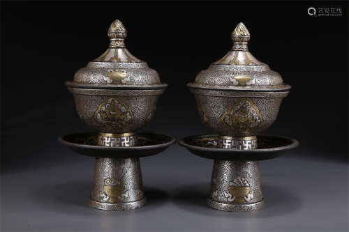 A Set of Cast Iron Lidded Bowls with Holders.