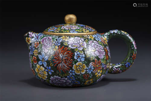 A Purple Clay Teapot with Flowers Pattern.