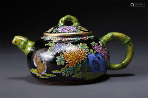An Enameled Purple Clay Teapot.