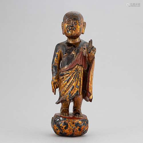 A Chinese wood gilt and lacquer sculpture of a boy, 20th Cen...