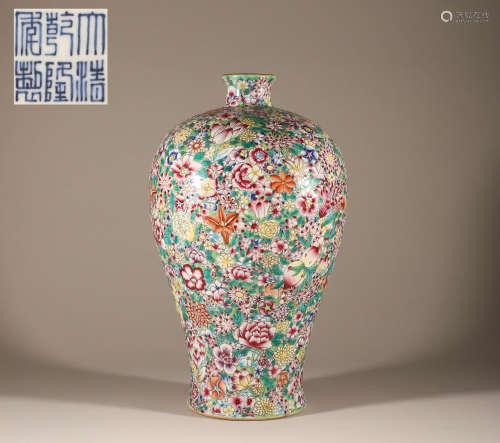 A plum vase full of flowers