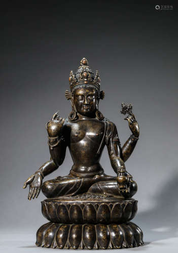 A Chinese Bronze Four-Arms 
Avalokiteshvara Statue