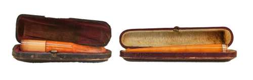 An amber cigar holder with a 9 carat gold mount and another ...