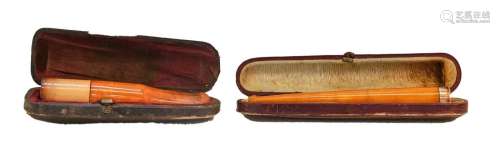 An amber cigar holder with a 9 carat gold mount and another ...